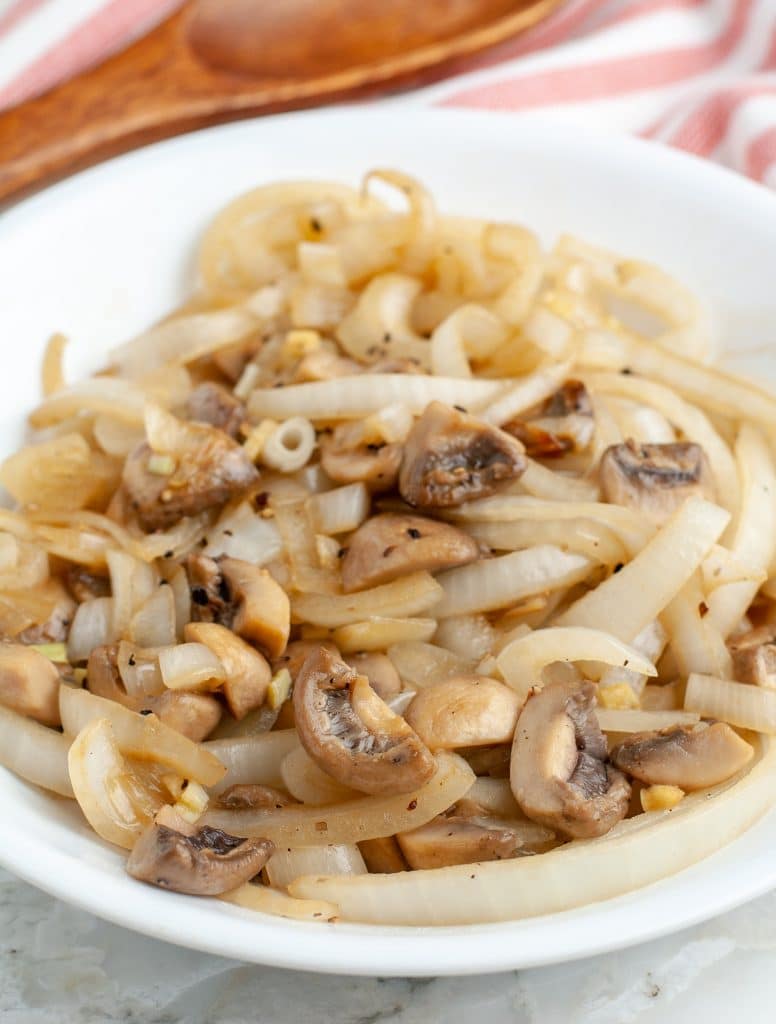 Bowl of cooked onions and mushrooms.