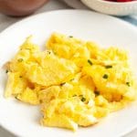 Scrambled eggs on plate.