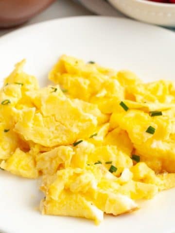 Scrambled eggs on plate.