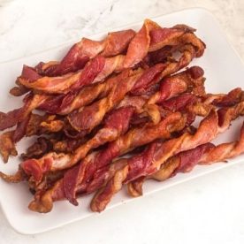 Twisted bacon on plate.