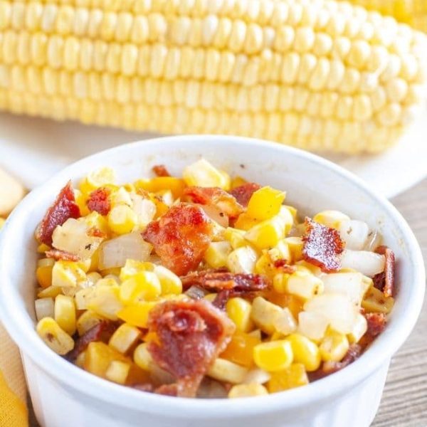 Bowl of corn and bacon bits.