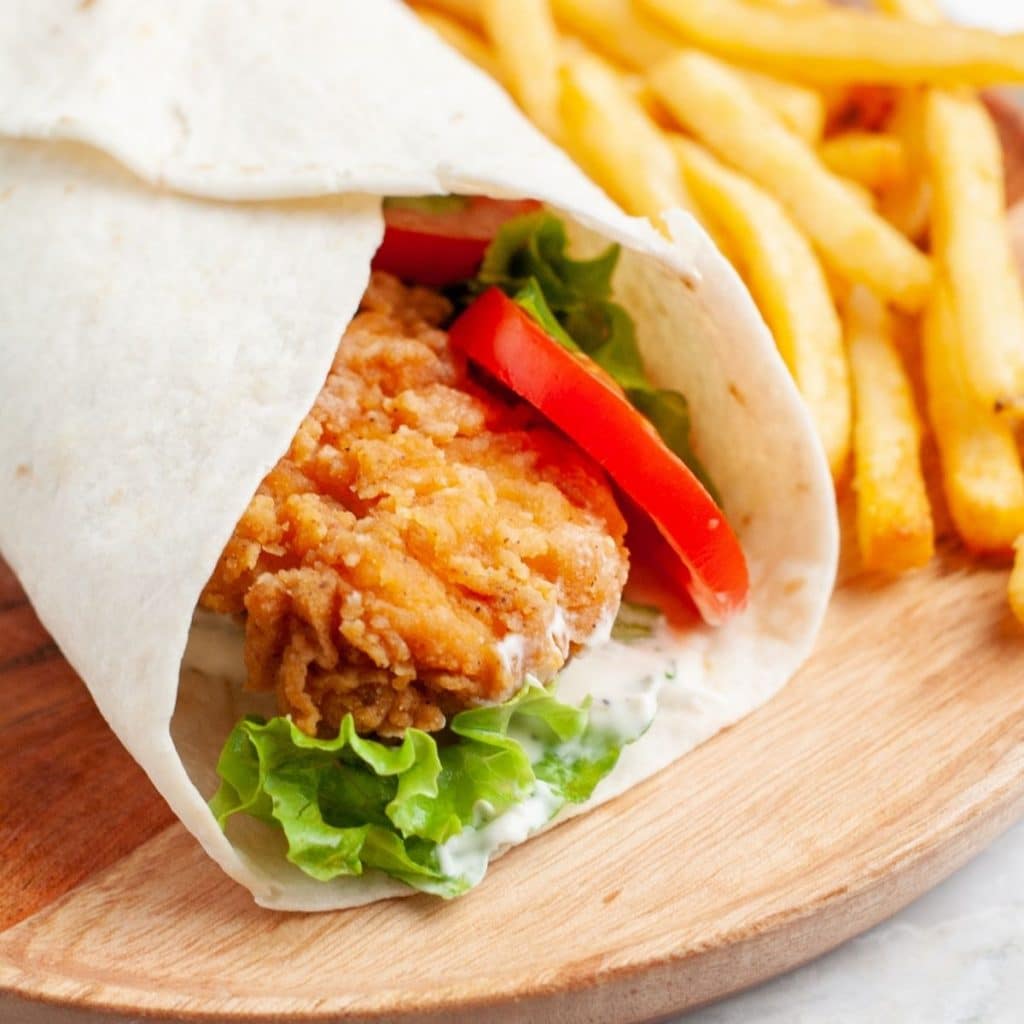 Fried chicken wrap on a plate.