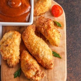 Chicken tenders on cutting board.