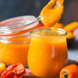 Jar with orange hot sauce.
