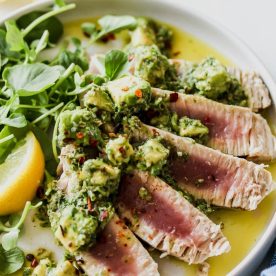 Sliced tuna steak with avocado salsa.