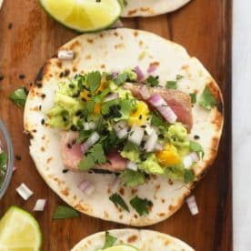 Tortilla topped with salsa and tuna.