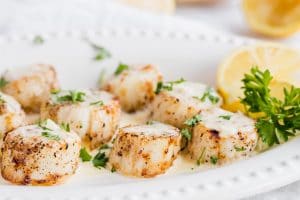 Cooked scallops on a plate.