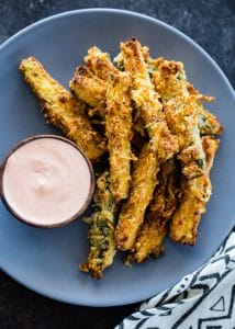 Zucchini fries on plate with sauce.