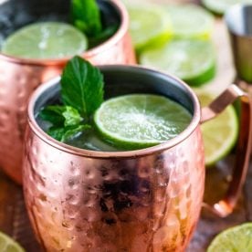 Copper cup filled with drink and lime.