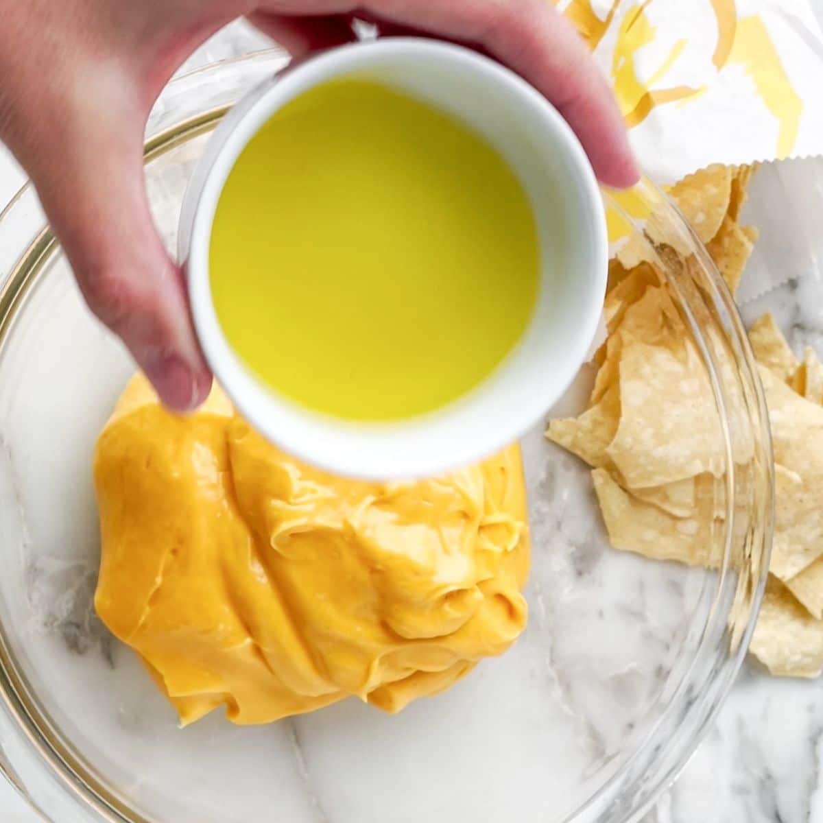 Bowl with cheese sauce and jalapeno brine.