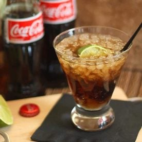 Bottles of Coke with glass and Coke.