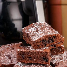 Brownies cut and stacked on plate.