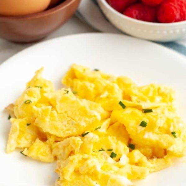 Plate full of scrambled eggs.