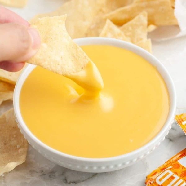 Chip dipped into cheese sauce.