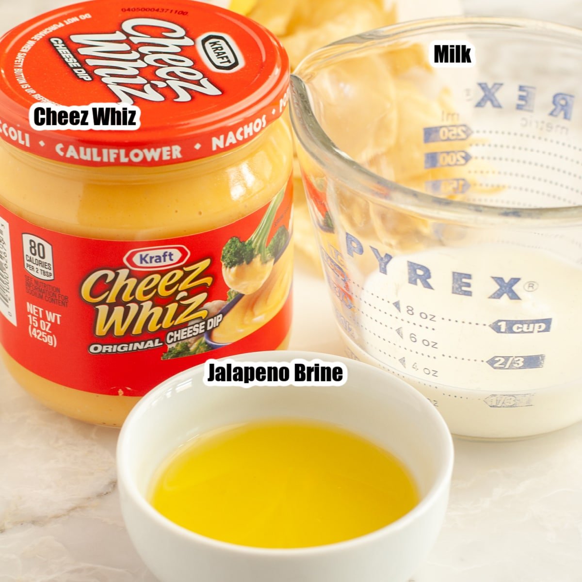 Jar of Cheez Whiz, milk, and jalapeno brine.