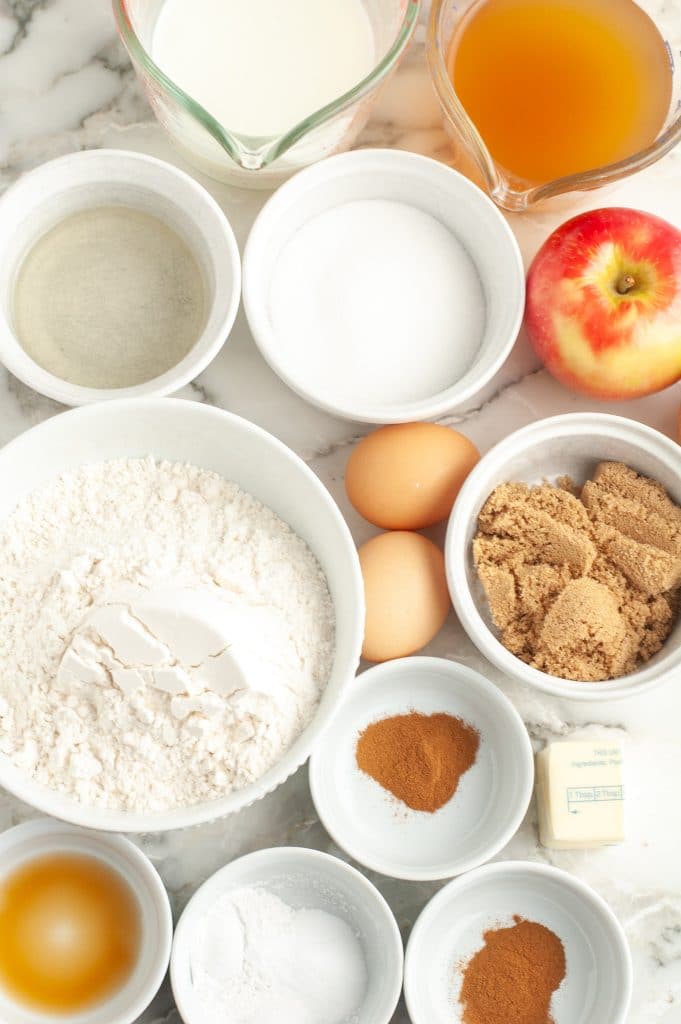 Bowls of sugar, flour, vanilla, spices and eggs.