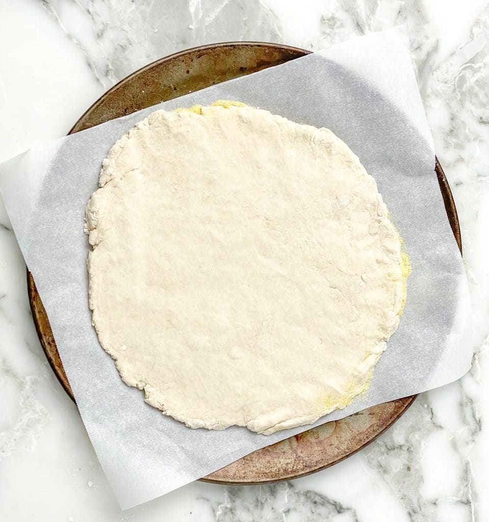 Pizza dough rolled into crust.