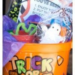 Orange halloween bucket with treats.