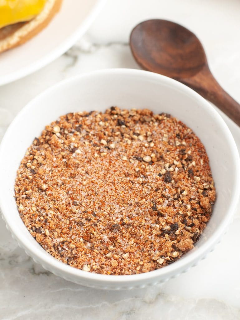 Wooden spoon with bowl of spices.