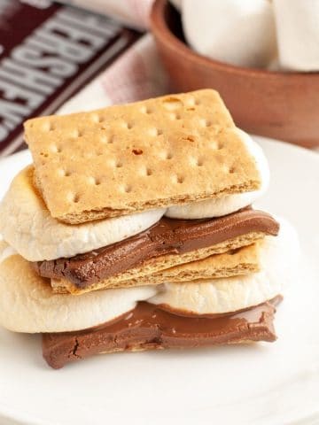 S'mores sitting on a stack of plates.