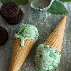 Two cones of mint Oreo Ice Cream lay flat on the counter