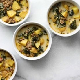 4 white bowls of zuppa toscano soup