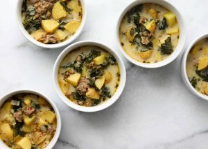 4 white bowls of zuppa toscano soup