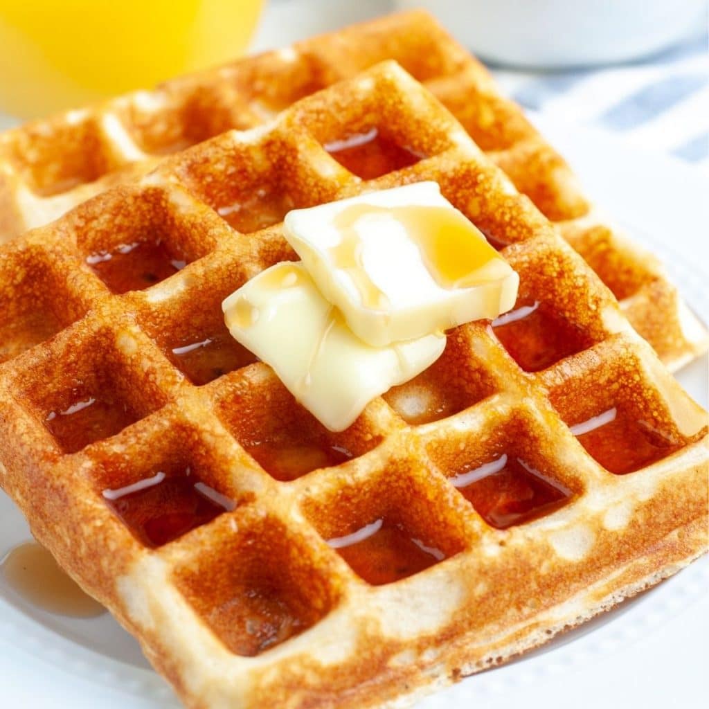 Two square waffles on a plate.