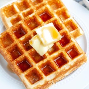 Plate of waffles with butter.