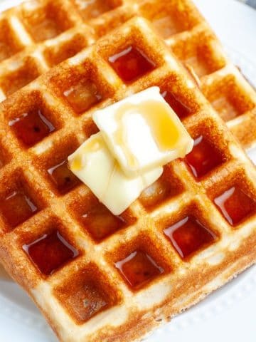 Plate of waffles with butter.