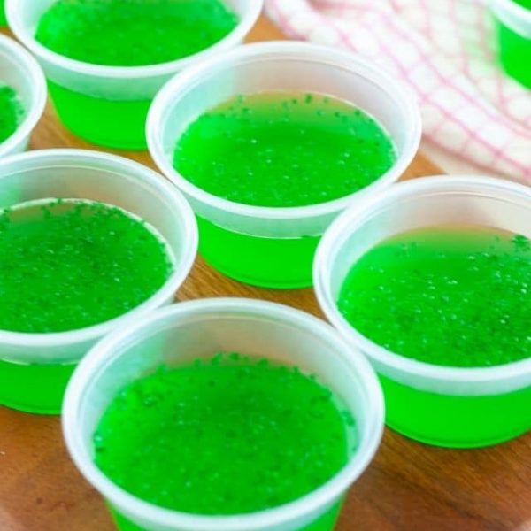 Green Jello in small cups.