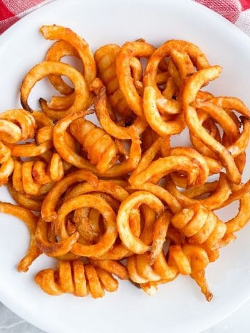 Bowl of curly french fries.