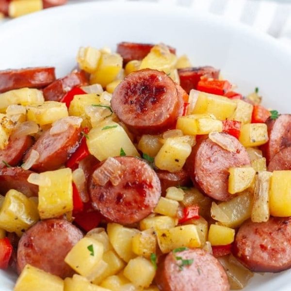 Bowl of diced potatoes and sliced sausage.