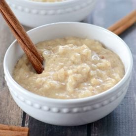 Bowl of rice pudding with cinnamon stick.