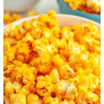 Orange popcorn in a bowl.
