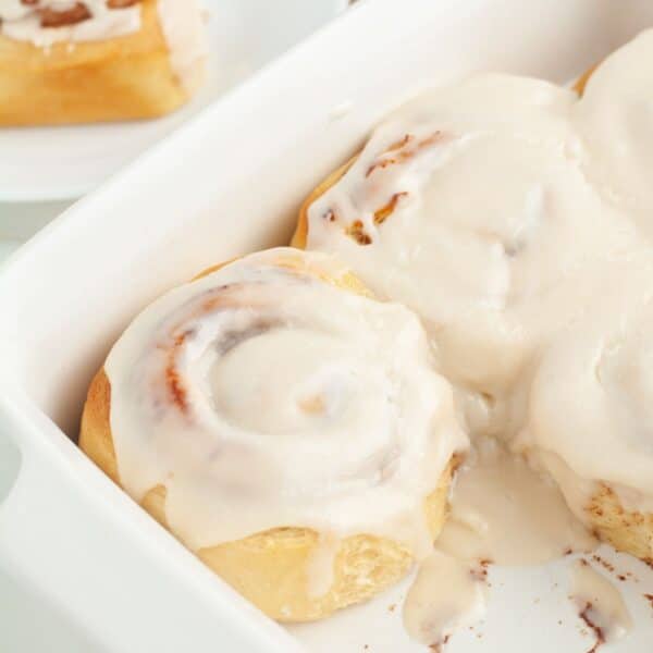 Dish of cinnamon rolls with icing.