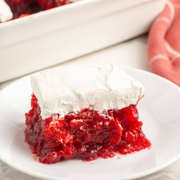 Piece of JELLO salad with cream cheese on plate.