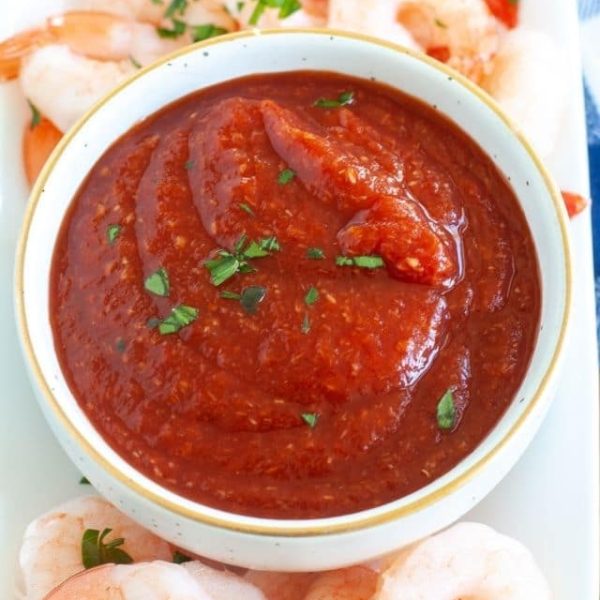 Bowl of cocktail sauce with shrimp.