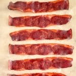 Oven cooked turkey bacon on paper.