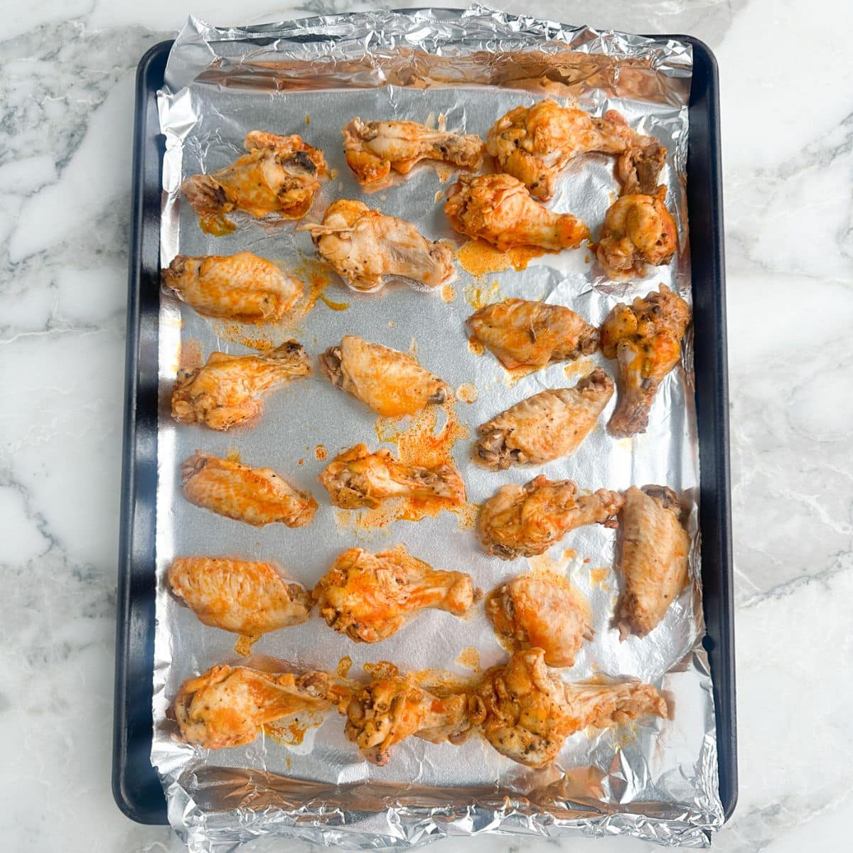 Baking pan with chicken wings.