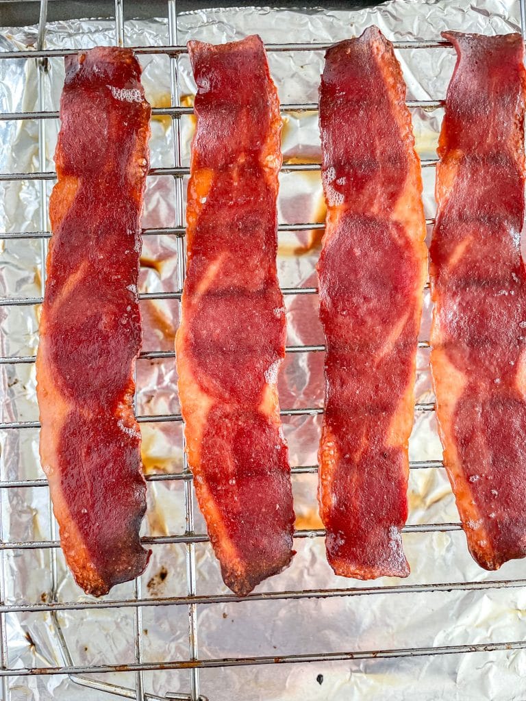 Cooked bacon on baking sheet.