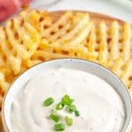 Bowl of cream dip and waffle fries.
