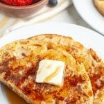 French toast on a plate with pat of butter.