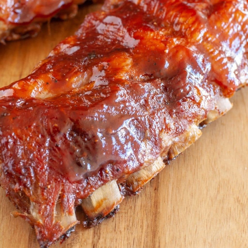 Cooked ribs with BBQ sauce.