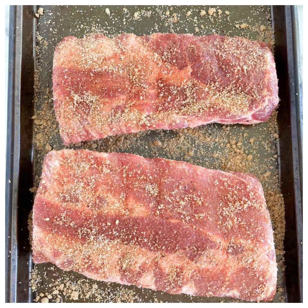 Uncooked ribs covered in seasoning.