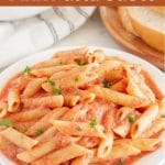Plate of penne pasta with sauce.