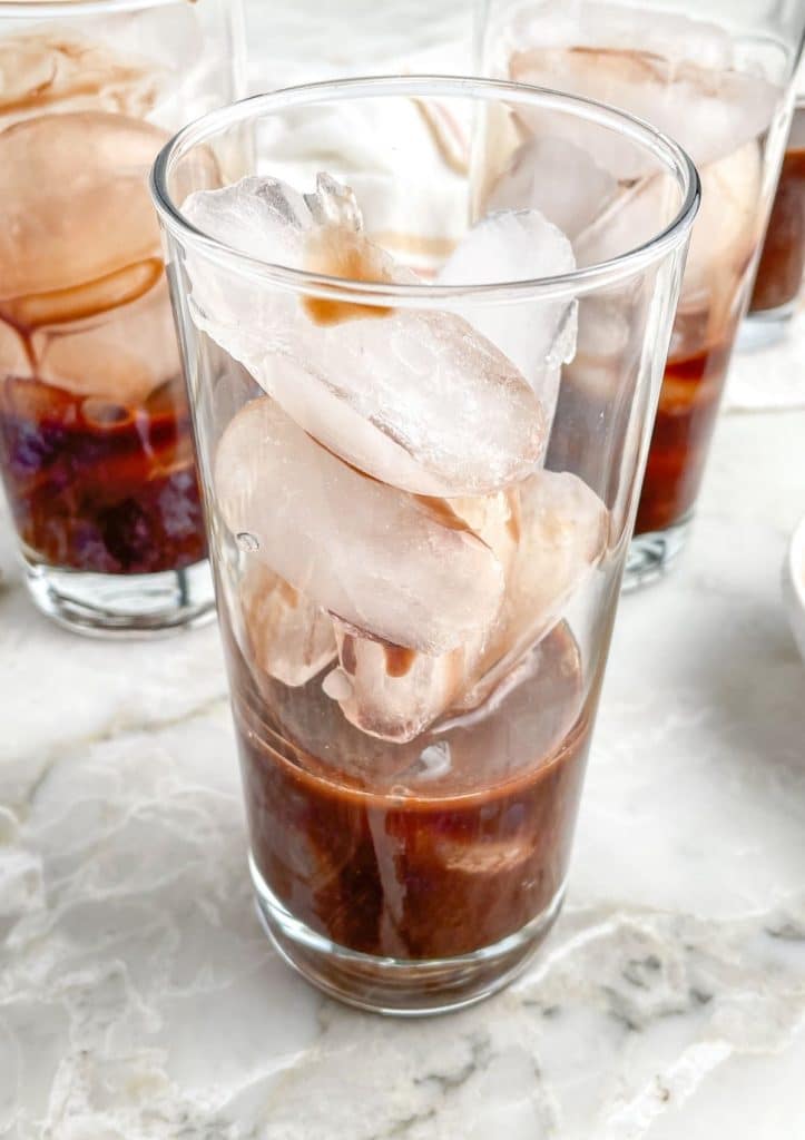 Chocolate syrup in glass full of ice.