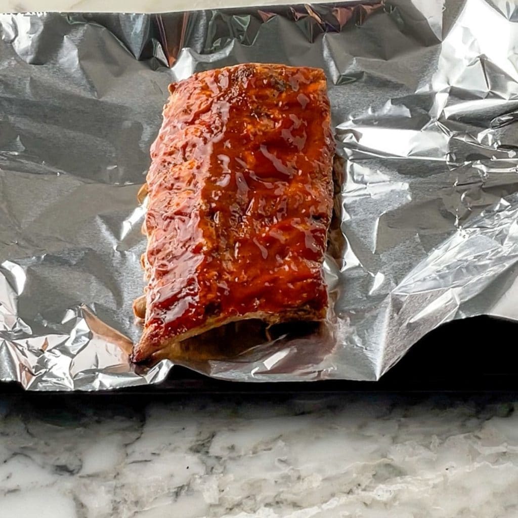 Cooked ribs on foil.