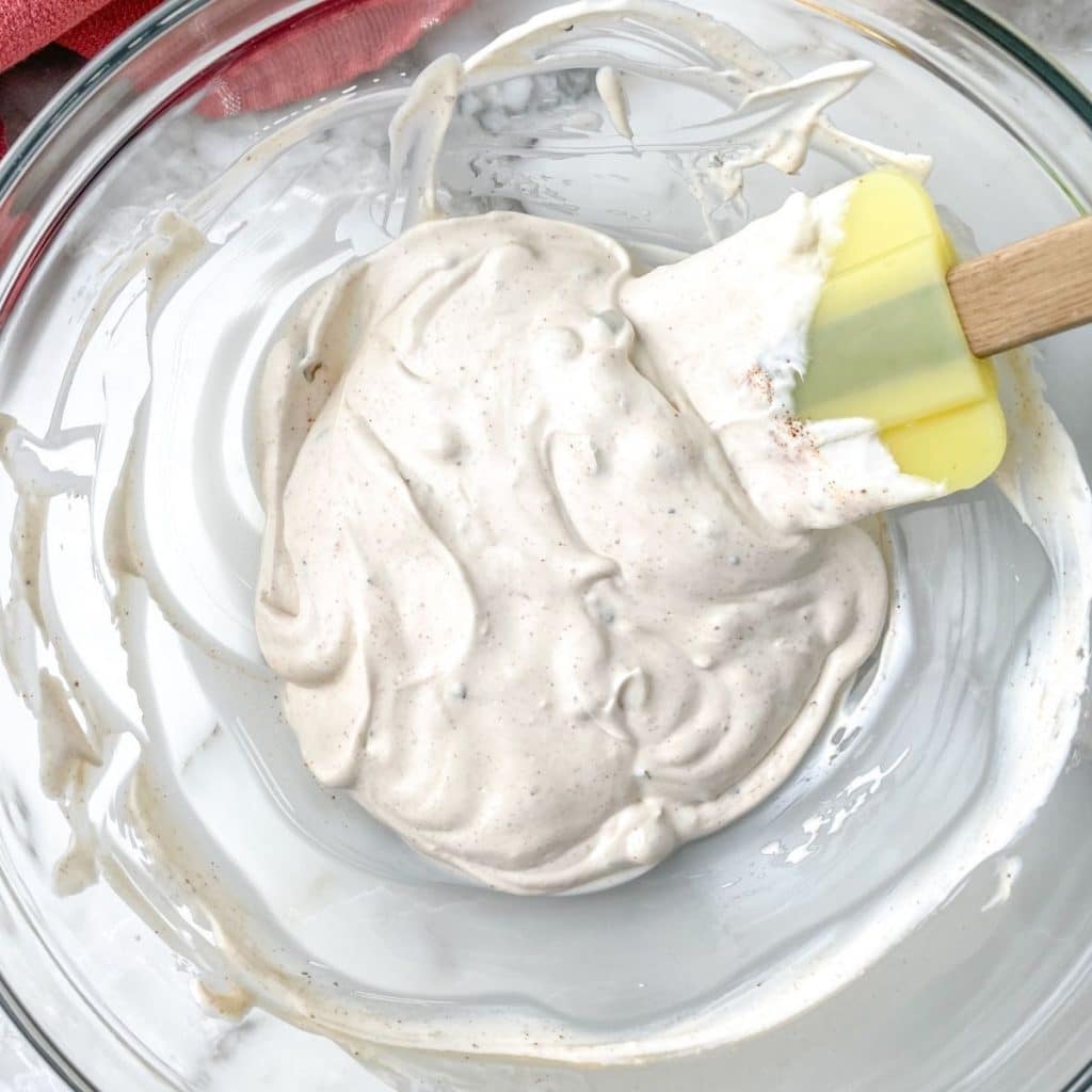 Bowl with cream mixture and spatula.