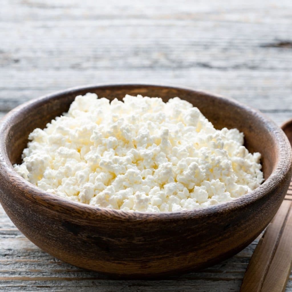 Bowl of cottage cheese in a wooden bowl. 